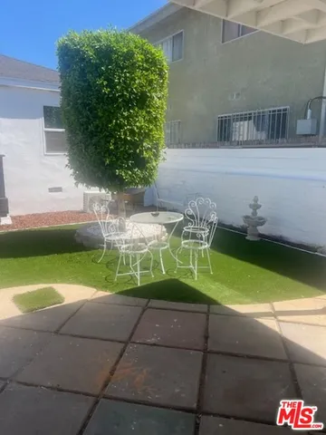 a view of backyard with swimming pool and outdoor seating