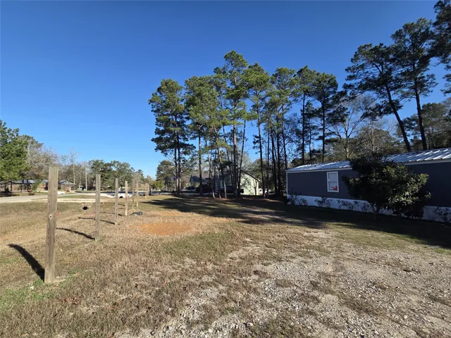 a view of a yard with a tree