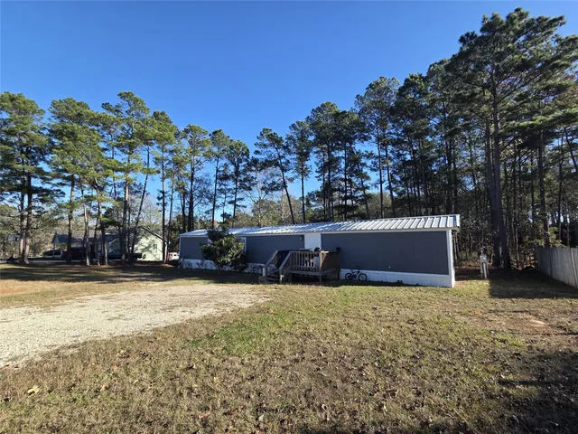 a view of swimming pool with outdoor seating and a garden