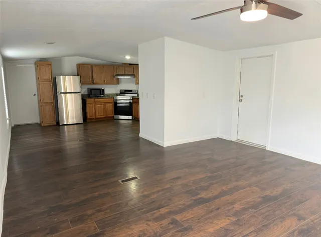 a view of kitchen view wooden floor and electronic appliances