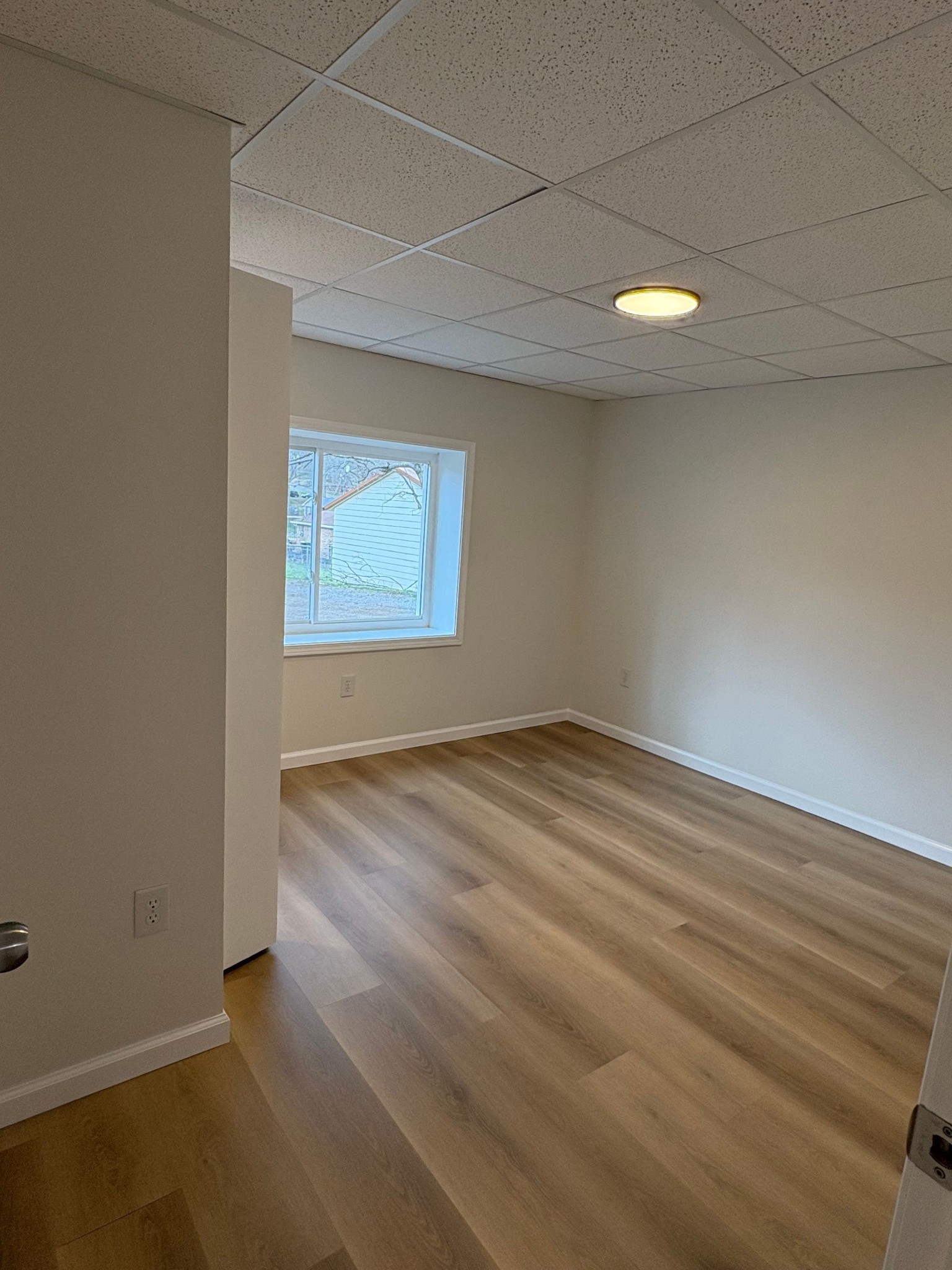 606 Dover Road, Unit 1 Clarksville, TN 37042 - Photo 7 of 12 an empty room with wooden floor and windows