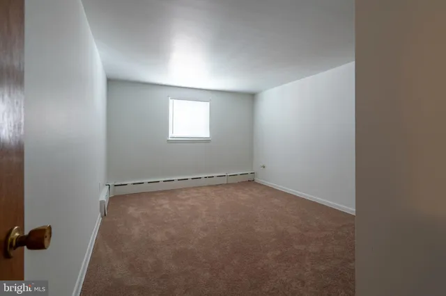 an empty room with a empty space and a window