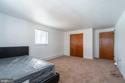 a bedroom with bed and window