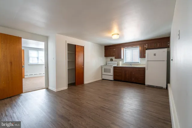 a view of a kitchen with a sink and a refrigerator