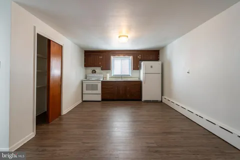 a view of a kitchen with a sink and a refrigerator