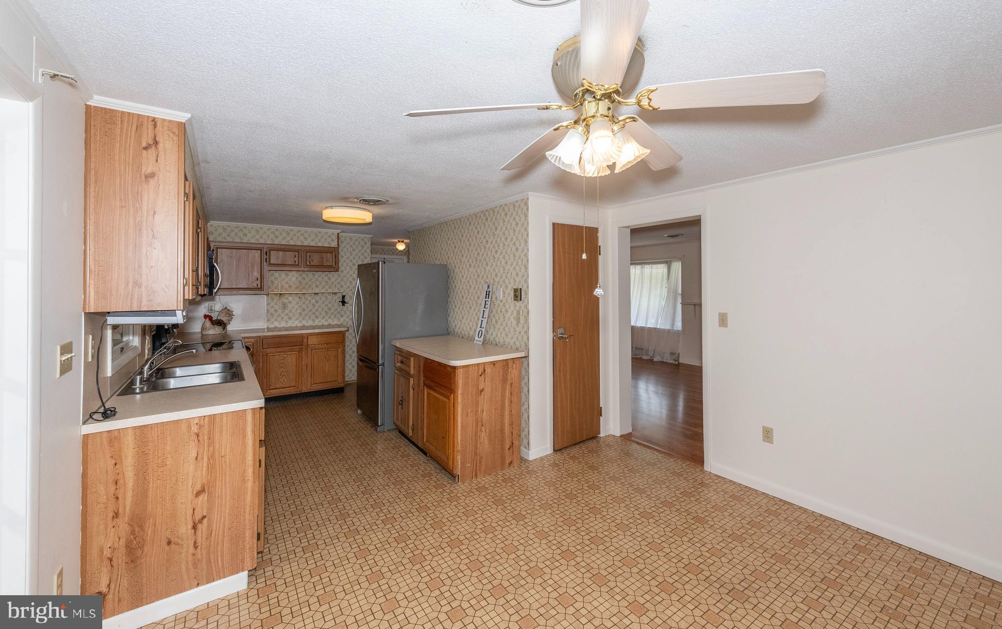 11320 Baker Road Keymar, MD 21757 - Photo 6 of 46 a view of a kitchen with a sink and a refrigerator