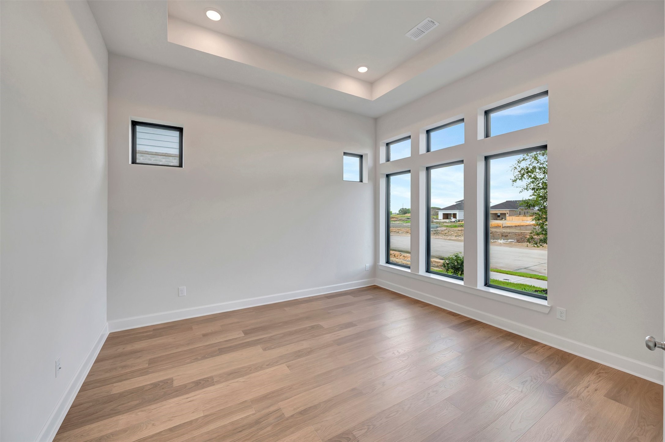 2718 Cottage Place Rosharon, TX 77583 - Photo 13 of 50 a view of an empty room with a window and wooden floor