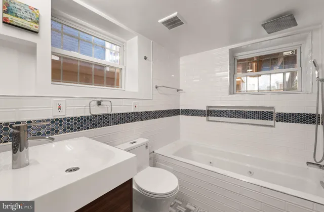 a bathroom with a sink a toilet and bathtub