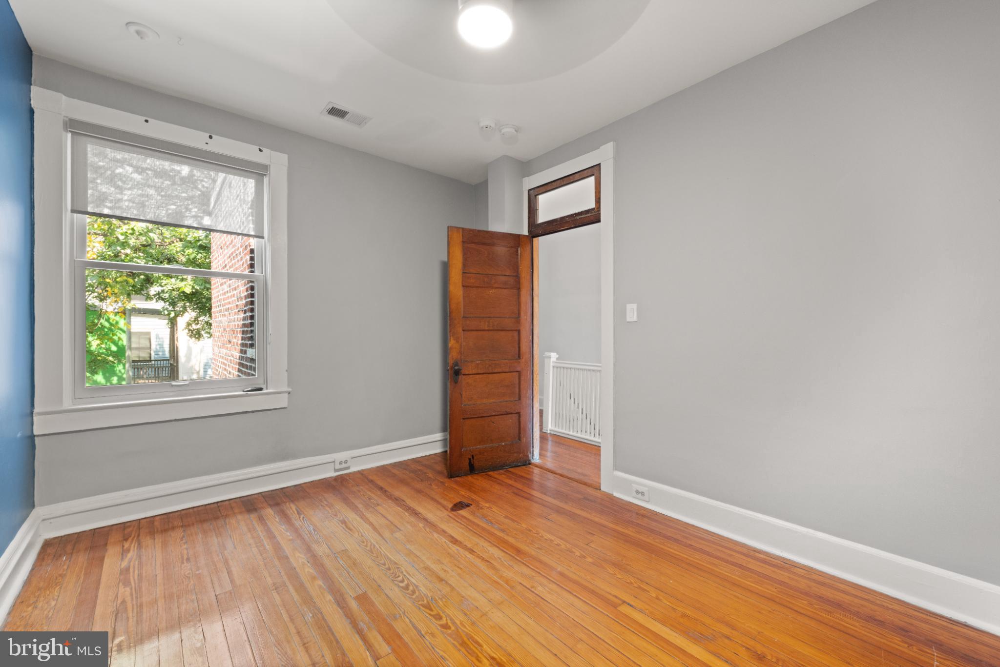 445 Newton Place Northwest Washington, DC 20010 - Photo 15 of 26 an empty room with wooden floor and windows