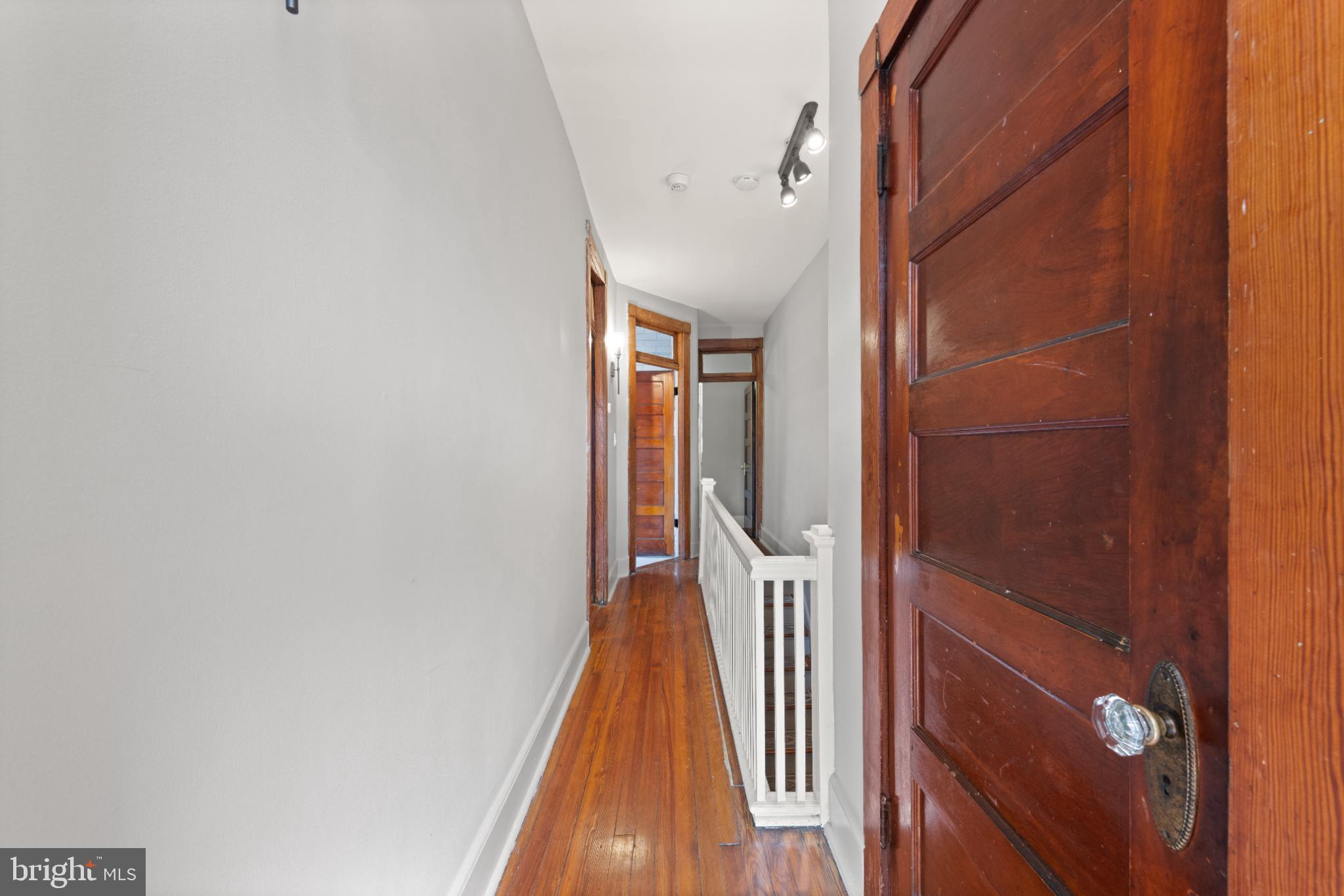 445 Newton Place Northwest Washington, DC 20010 - Photo 16 of 26 a view of a hallway with wooden floor and staircase