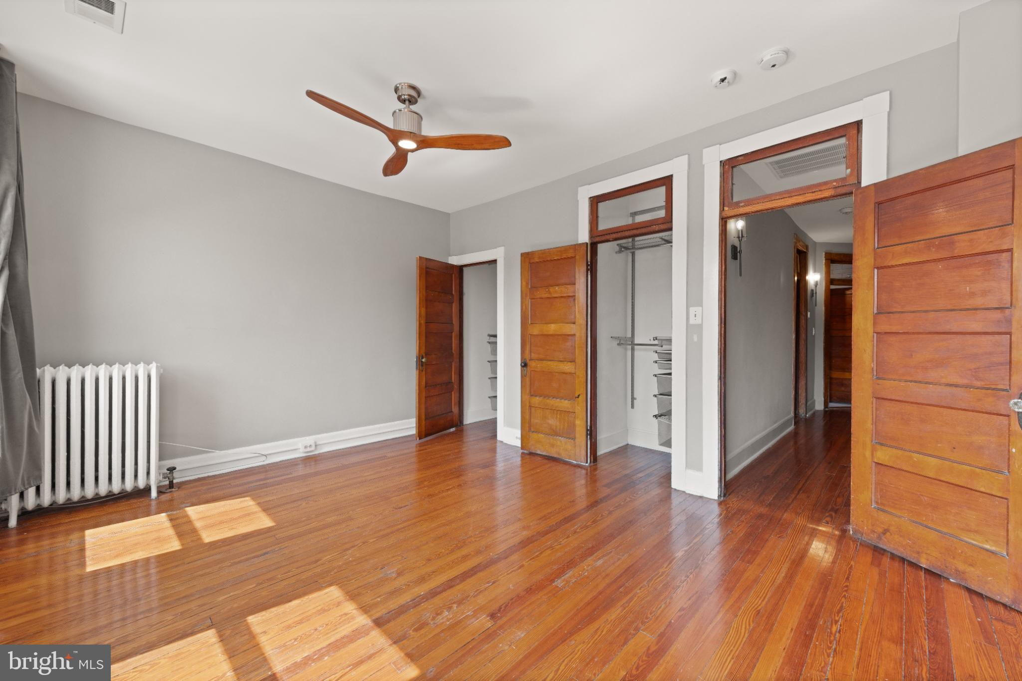 445 Newton Place Northwest Washington, DC 20010 - Photo 17 of 26 a view of an empty room with wooden floor and a window