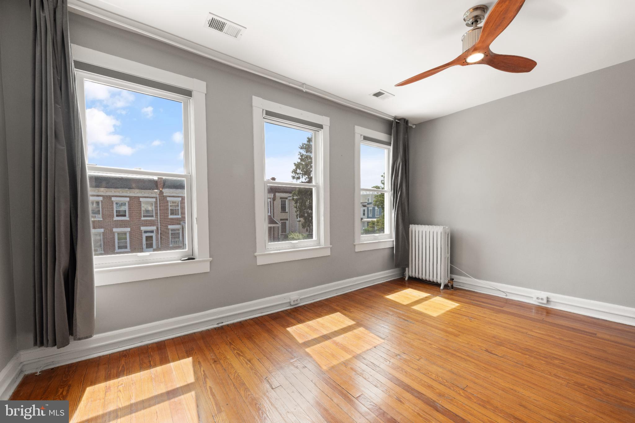445 Newton Place Northwest Washington, DC 20010 - Photo 18 of 26 a view of an empty room with wooden floor and a window