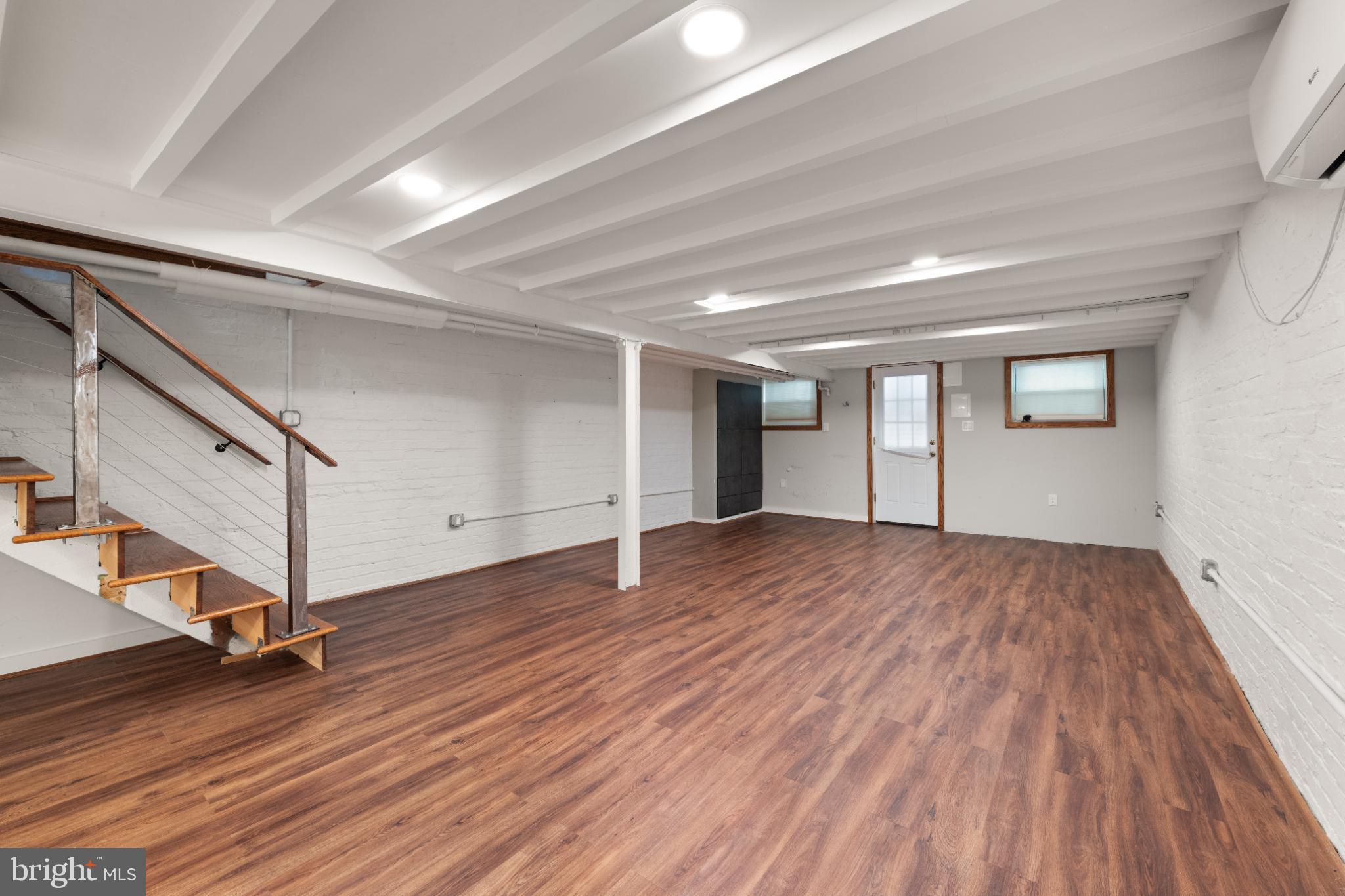 445 Newton Place Northwest Washington, DC 20010 - Photo 20 of 26 a view of an empty room with wooden floor and stairs