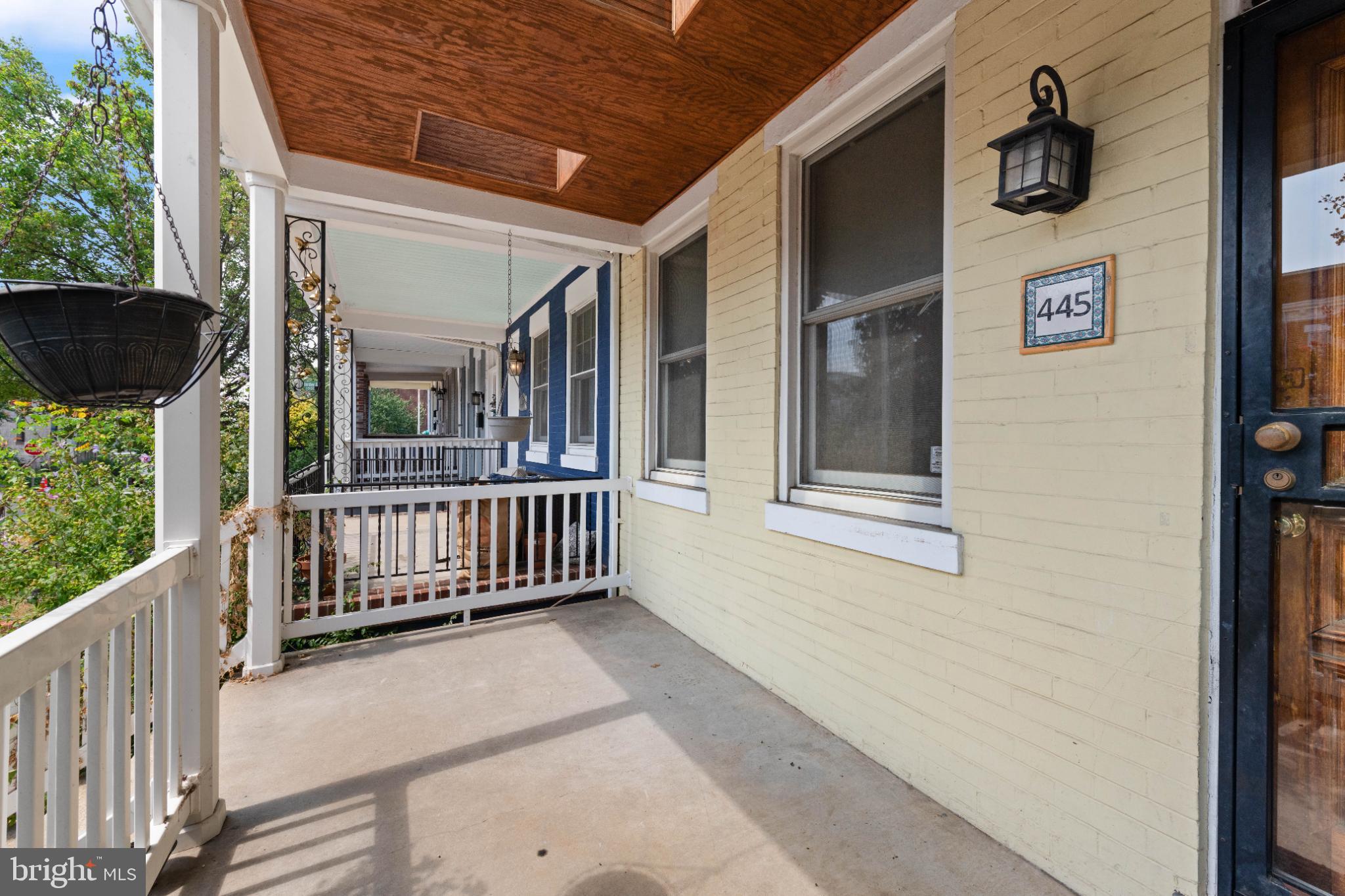 445 Newton Place Northwest Washington, DC 20010 - Photo 2 of 26 a porch with a bench in front of house