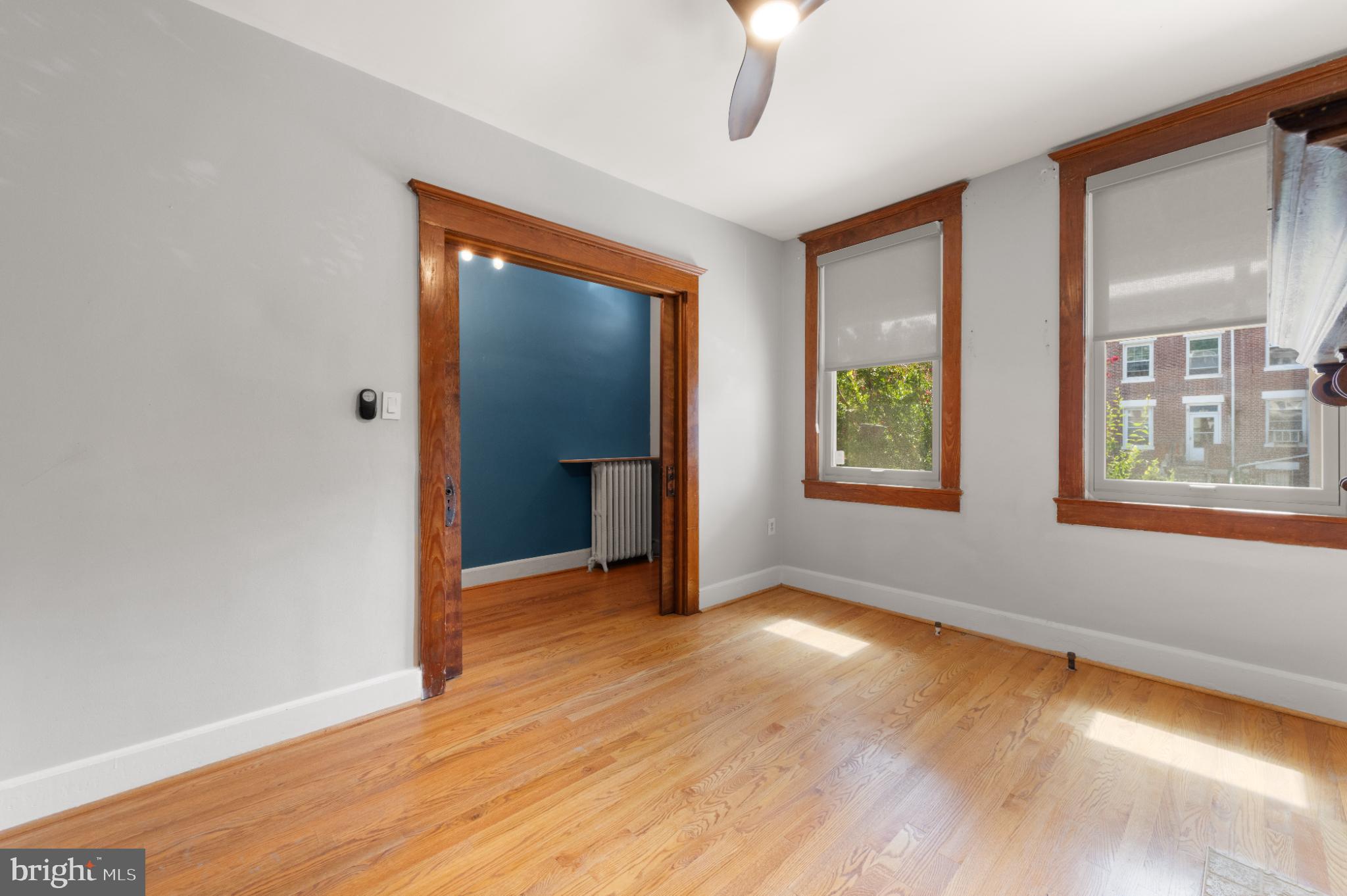445 Newton Place Northwest Washington, DC 20010 - Photo 6 of 26 a view of an empty room with window and wooden floor
