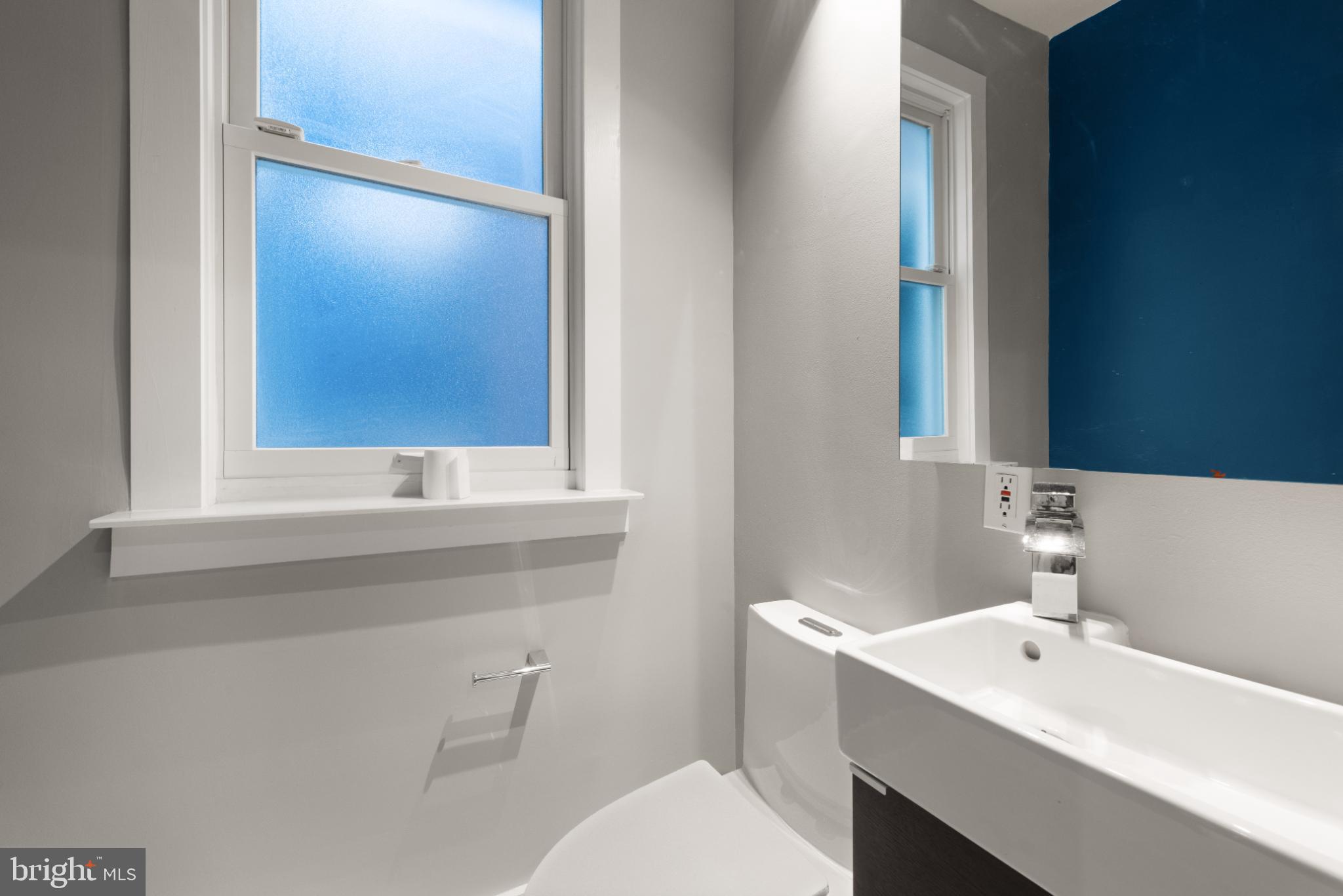 445 Newton Place Northwest Washington, DC 20010 - Photo 10 of 26 a bathroom with a sink a toilet and mirror