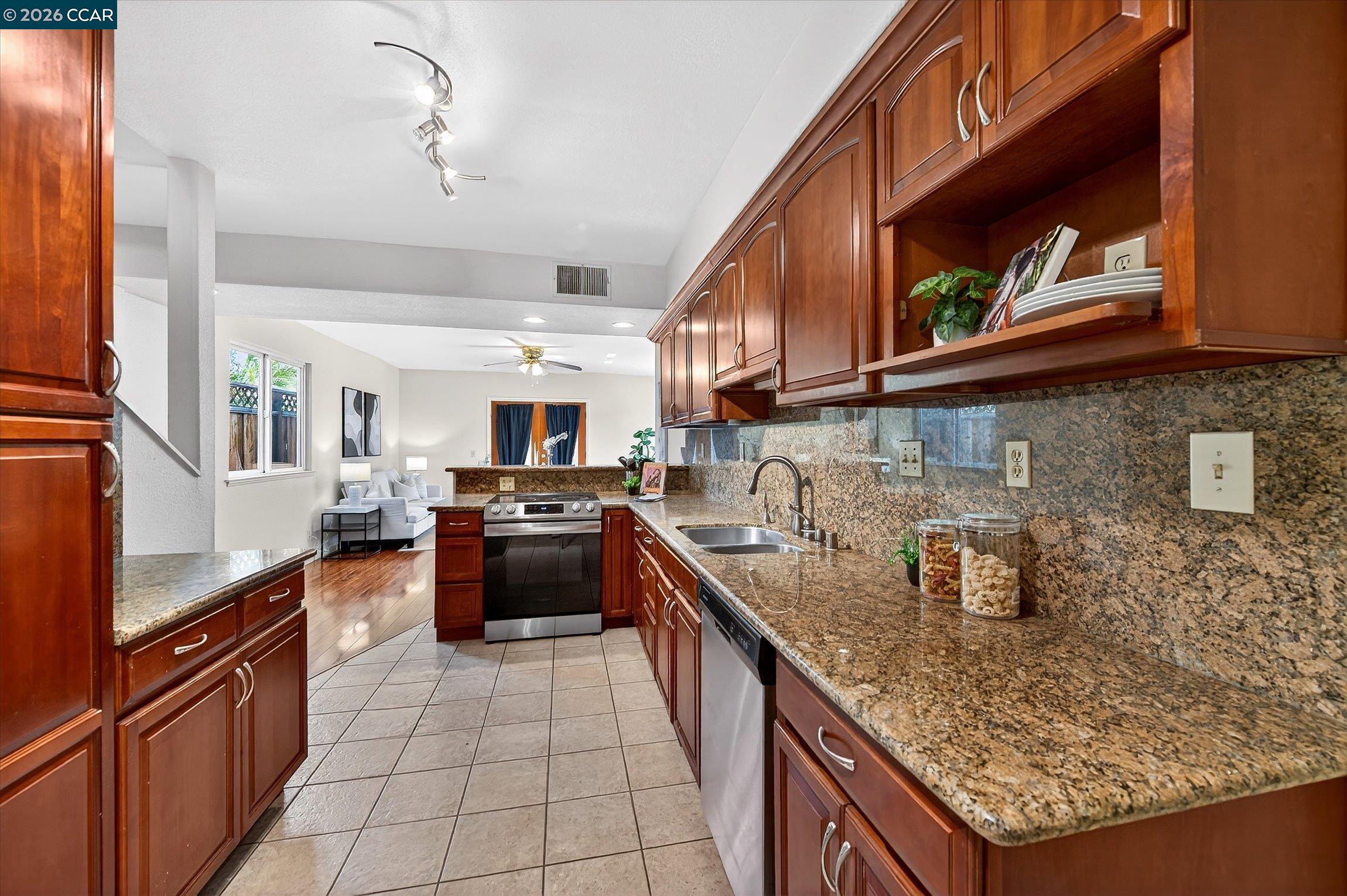 2659 3rd Street Livermore, CA 94550 - Photo 29 of 40 a kitchen with stainless steel appliances granite countertop a sink stove and refrigerator