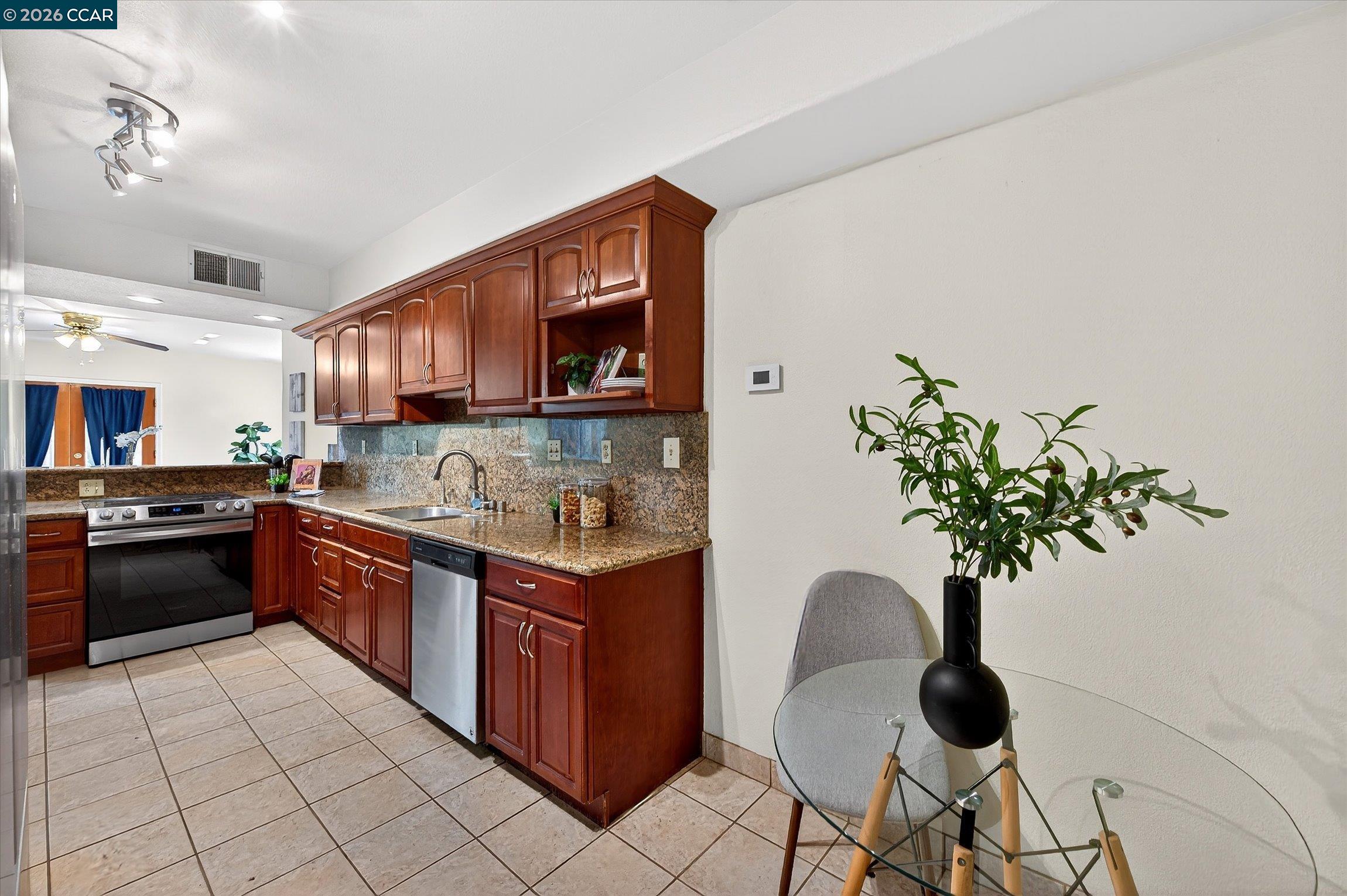 2659 3rd Street Livermore, CA 94550 - Photo 30 of 40 a kitchen with stainless steel appliances granite countertop a sink a stove and a microwave