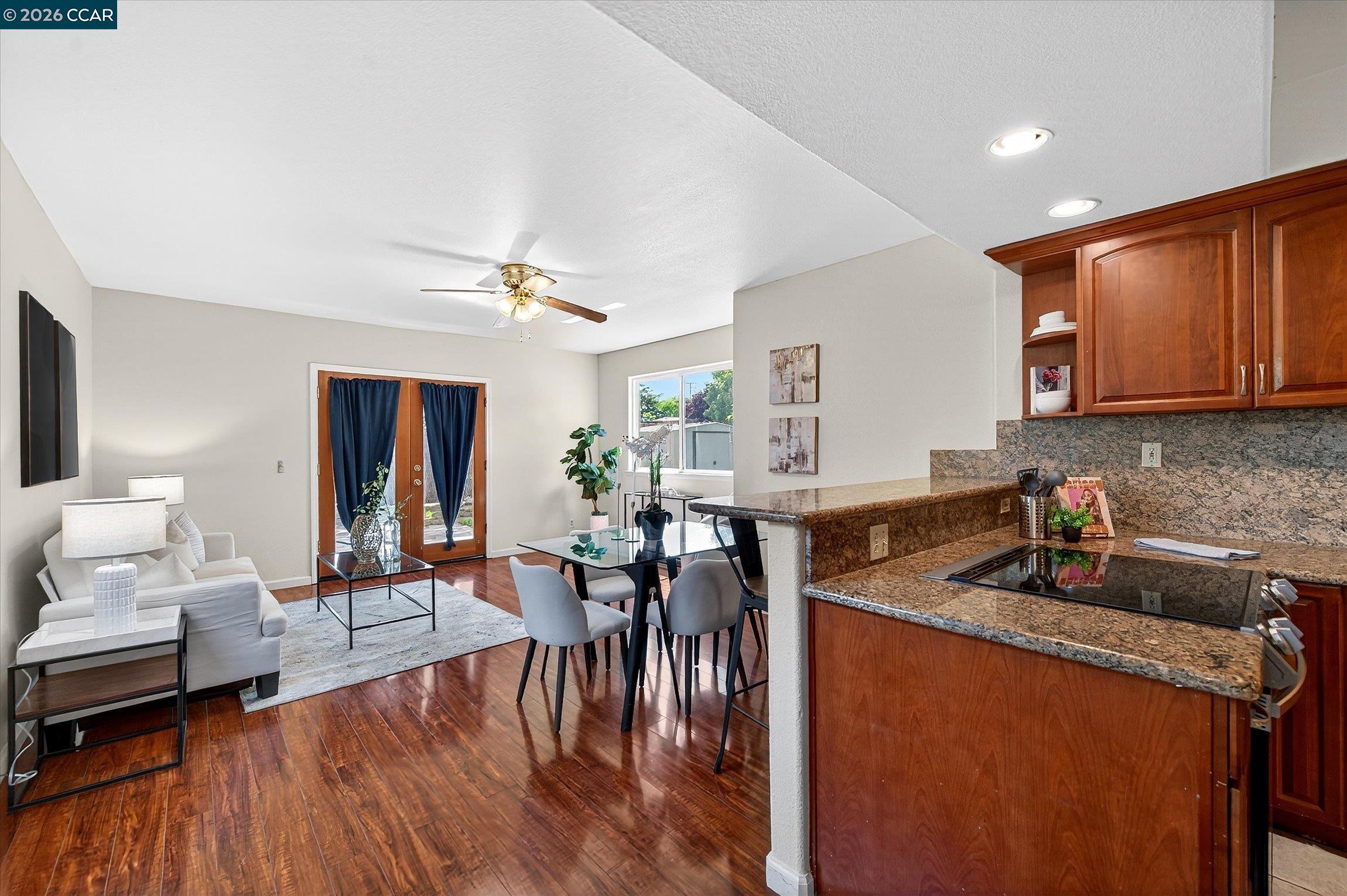 2659 3rd Street Livermore, CA 94550 - Photo 31 of 40 a kitchen with granite countertop a dining table chairs refrigerator and cabinets