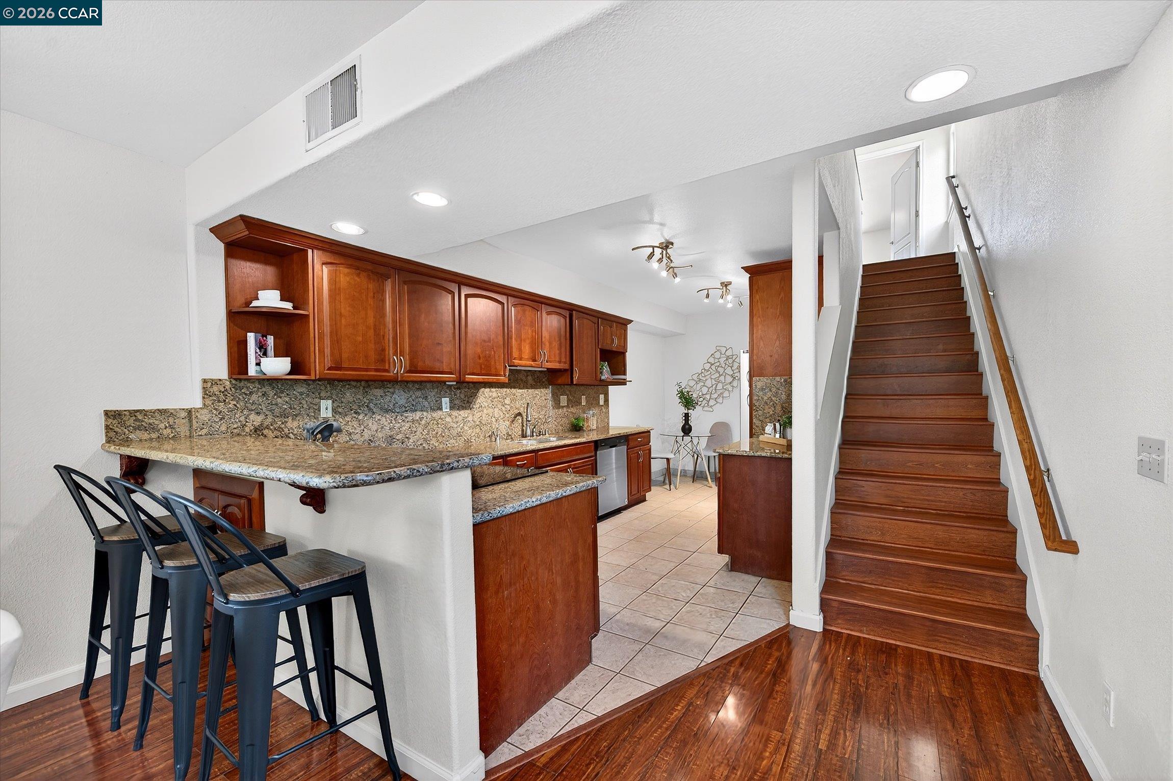 2659 3rd Street Livermore, CA 94550 - Photo 33 of 40 a kitchen with granite countertop wooden floors and wooden cabinets