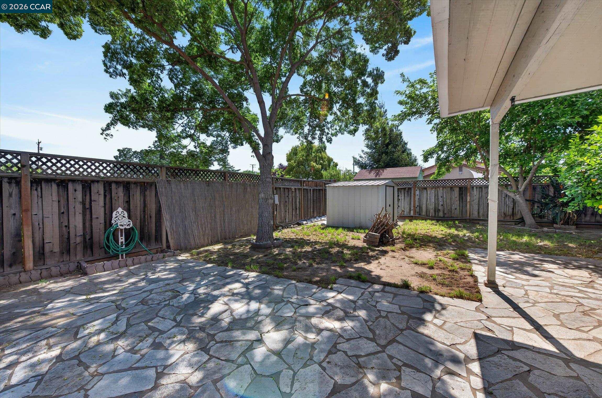 2659 3rd Street Livermore, CA 94550 - Photo 40 of 40 a backyard of a house with table and chairs a barbeque with wooden fence