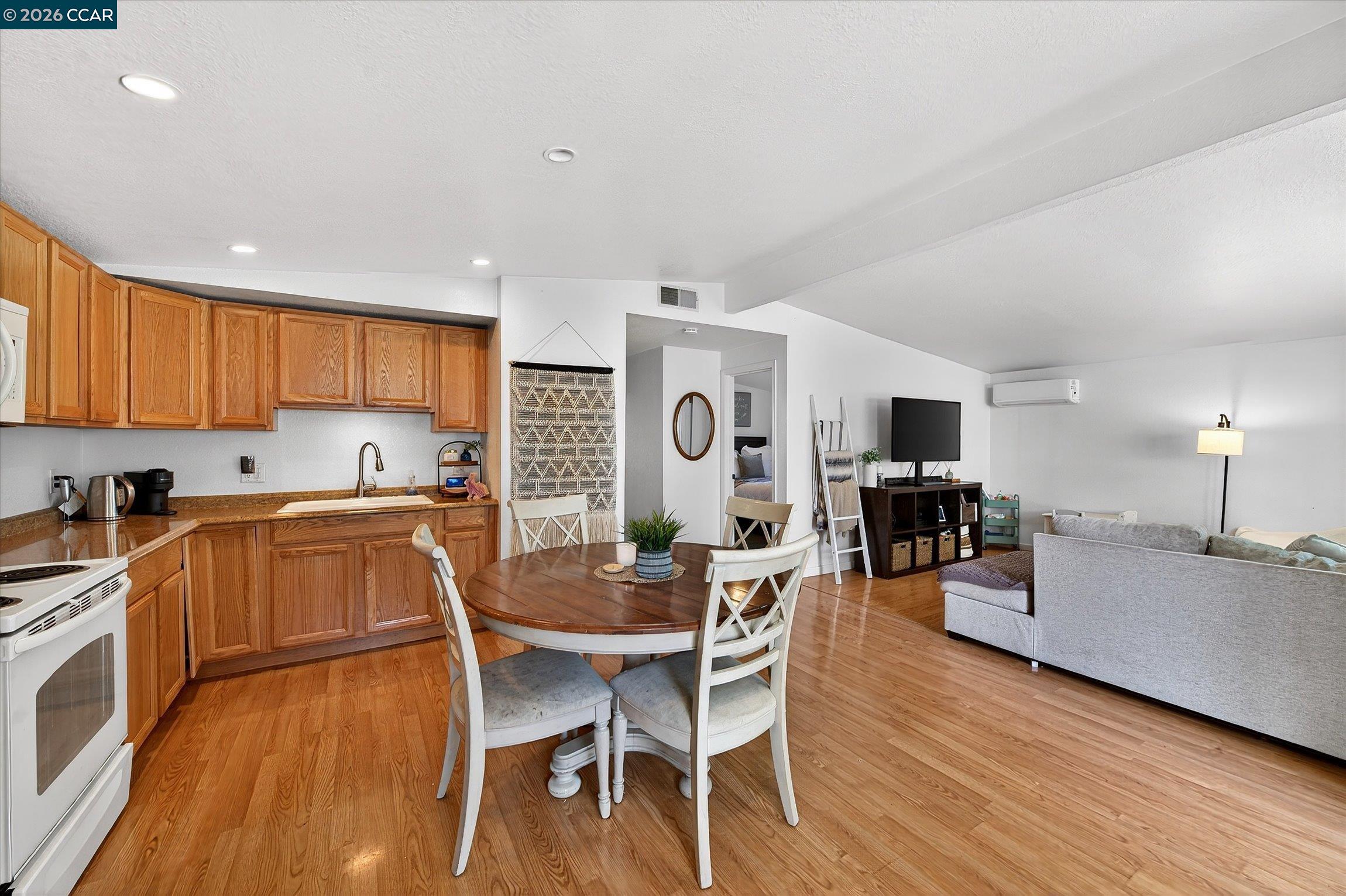 2659 3rd Street Livermore, CA 94550 - Photo 5 of 40 a kitchen with a table chairs microwave and cabinets