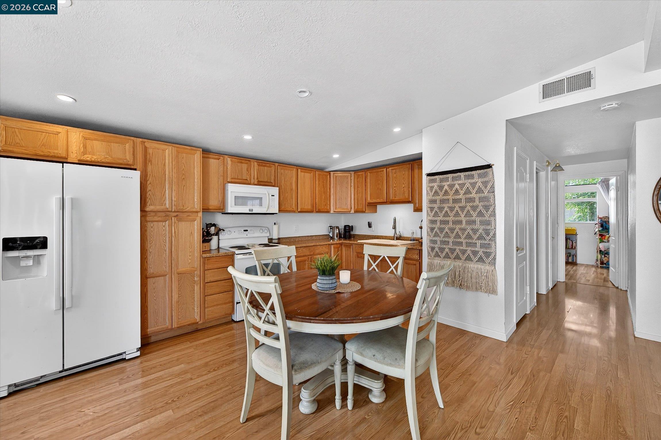 2659 3rd Street Livermore, CA 94550 - Photo 6 of 40 a view of a dining room with furniture a refrigerator and wooden floor