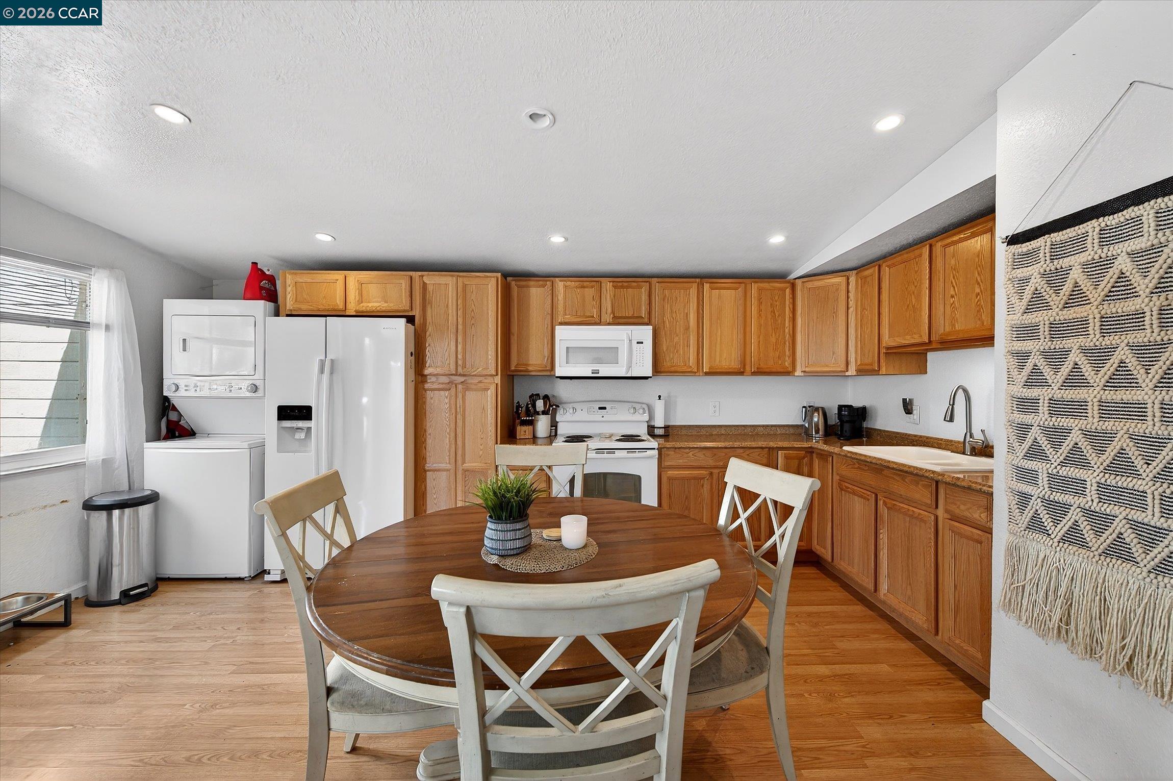 2659 3rd Street Livermore, CA 94550 - Photo 7 of 40 a kitchen with stainless steel appliances granite countertop a stove a refrigerator a kitchen island a table and chairs