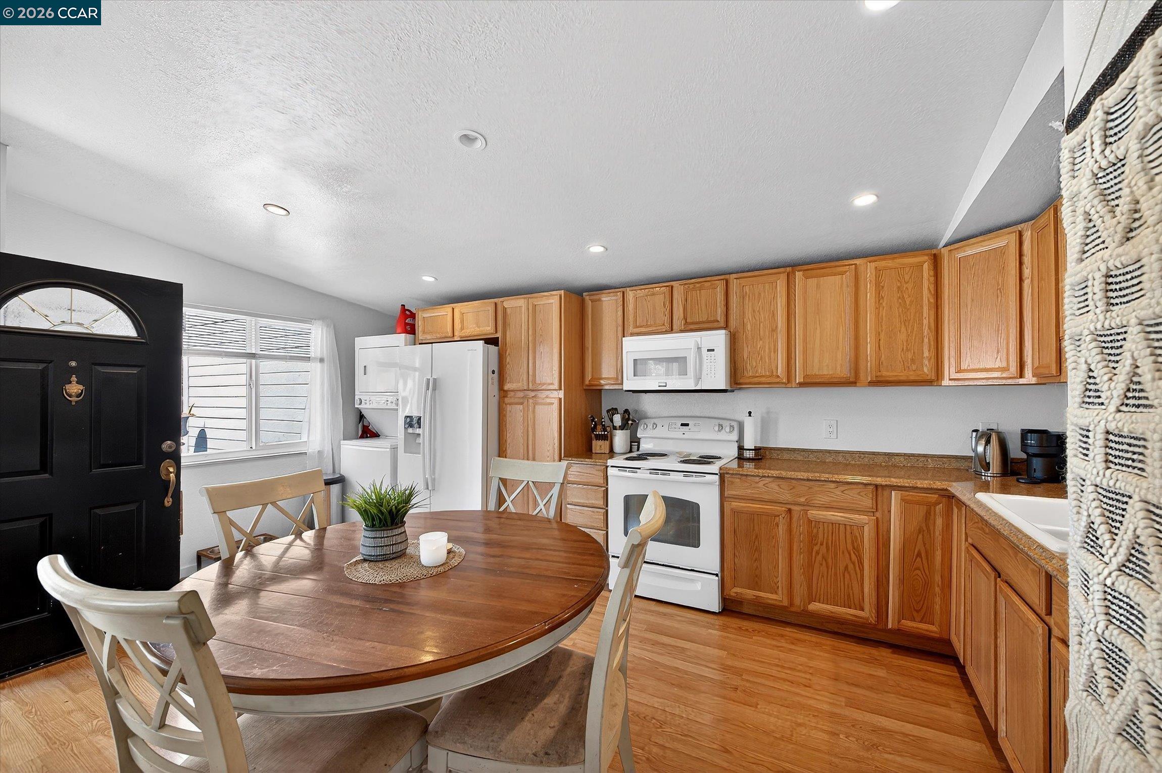 2659 3rd Street Livermore, CA 94550 - Photo 8 of 40 a kitchen with stainless steel appliances granite countertop a stove a sink a refrigerator white cabinets and wooden floor