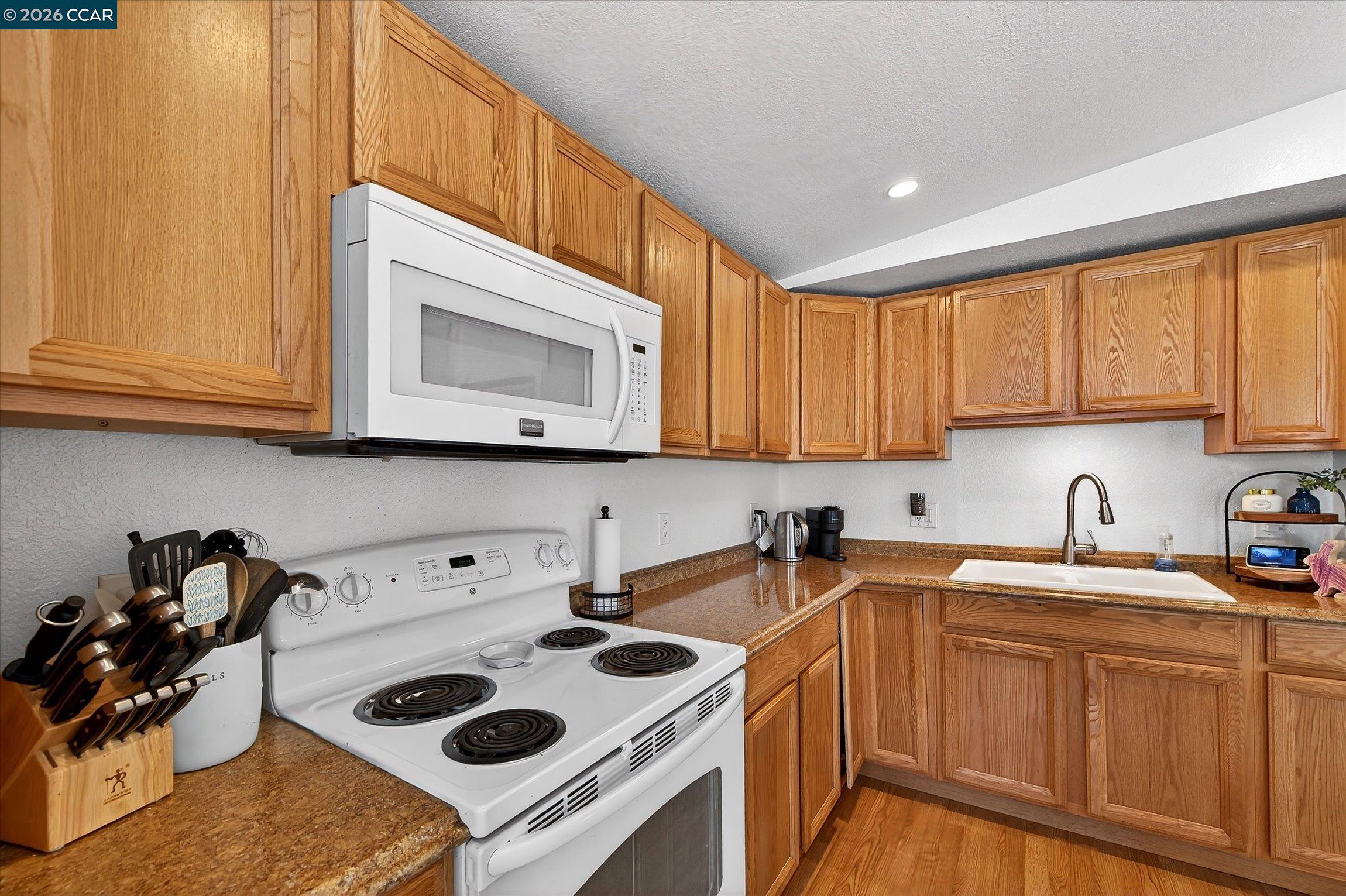 2659 3rd Street Livermore, CA 94550 - Photo 9 of 40 a kitchen with a sink a stove and cabinets