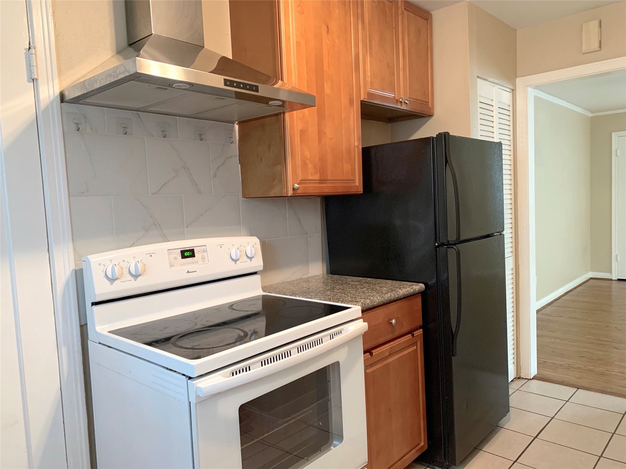 307 Avondale Street, Unit 1 Houston, TX 77006 - Photo 9 of 22 Stainless steel vent hood with over electric stove. Kitchen also has pantry. Refrigerator included!