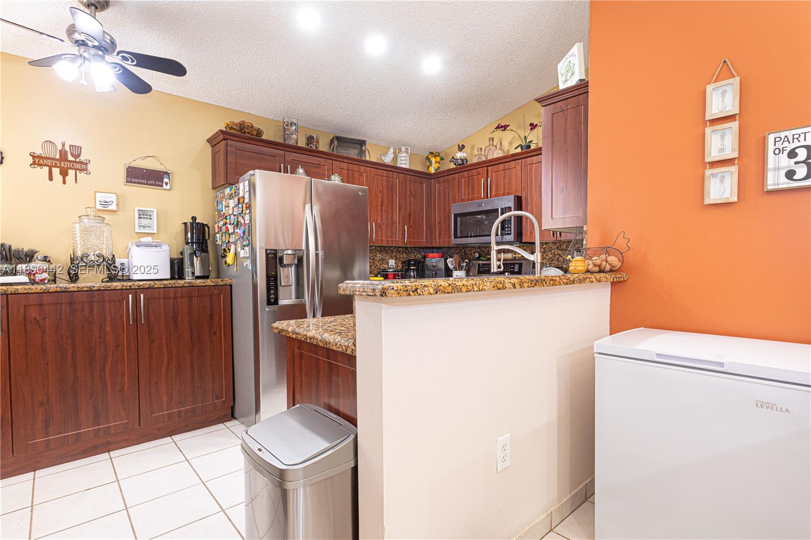 4810 Southwest 153rd Terrace Miramar, FL 33027 - Photo 11 of 41 a kitchen with refrigerator and cabinets