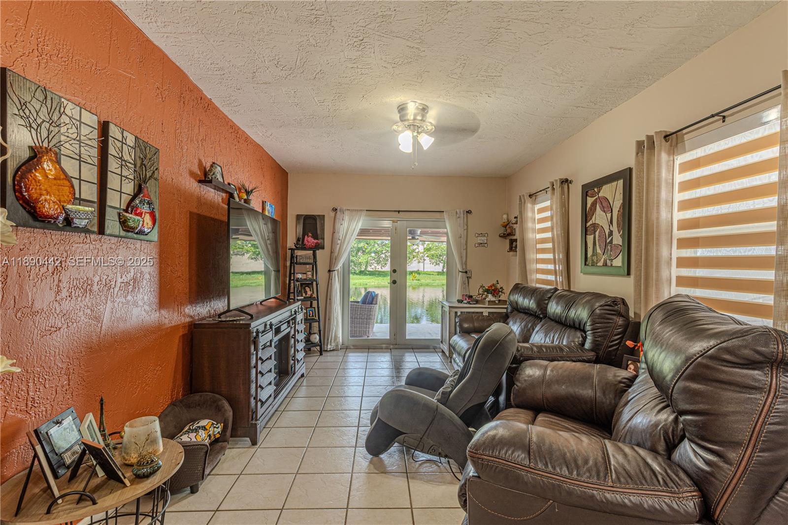 4810 Southwest 153rd Terrace Miramar, FL 33027 - Photo 14 of 41 a living room with furniture a flat screen tv and a large window