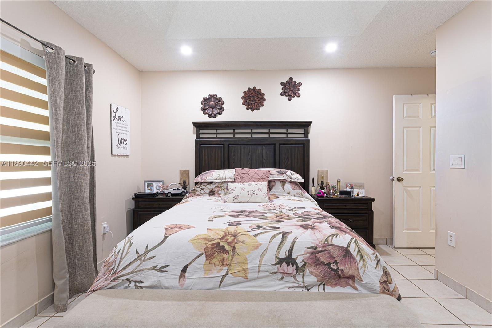 4810 Southwest 153rd Terrace Miramar, FL 33027 - Photo 15 of 41 a bed sitting in a bedroom next to a window