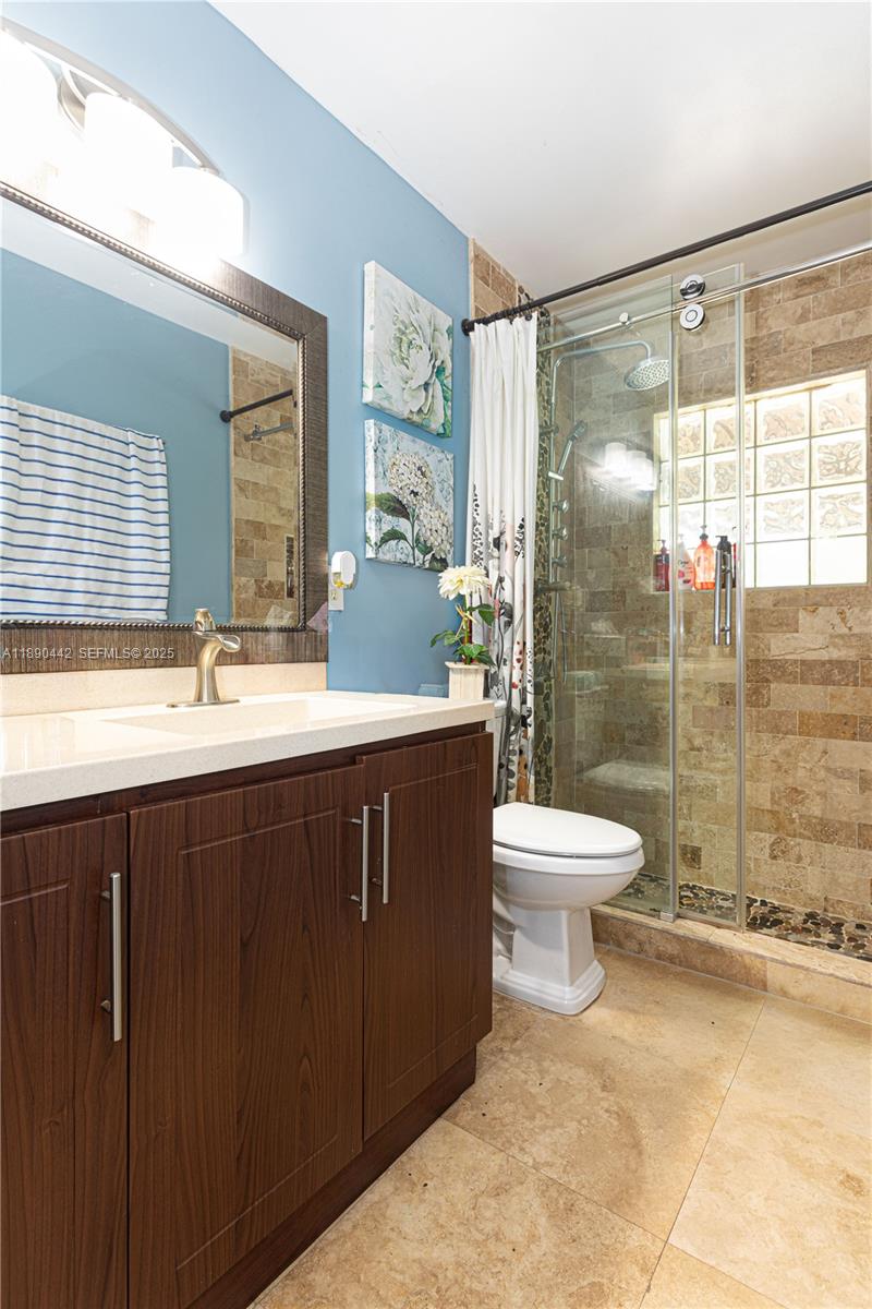 4810 Southwest 153rd Terrace Miramar, FL 33027 - Photo 22 of 41 a bathroom with a double vanity sink toilet and shower