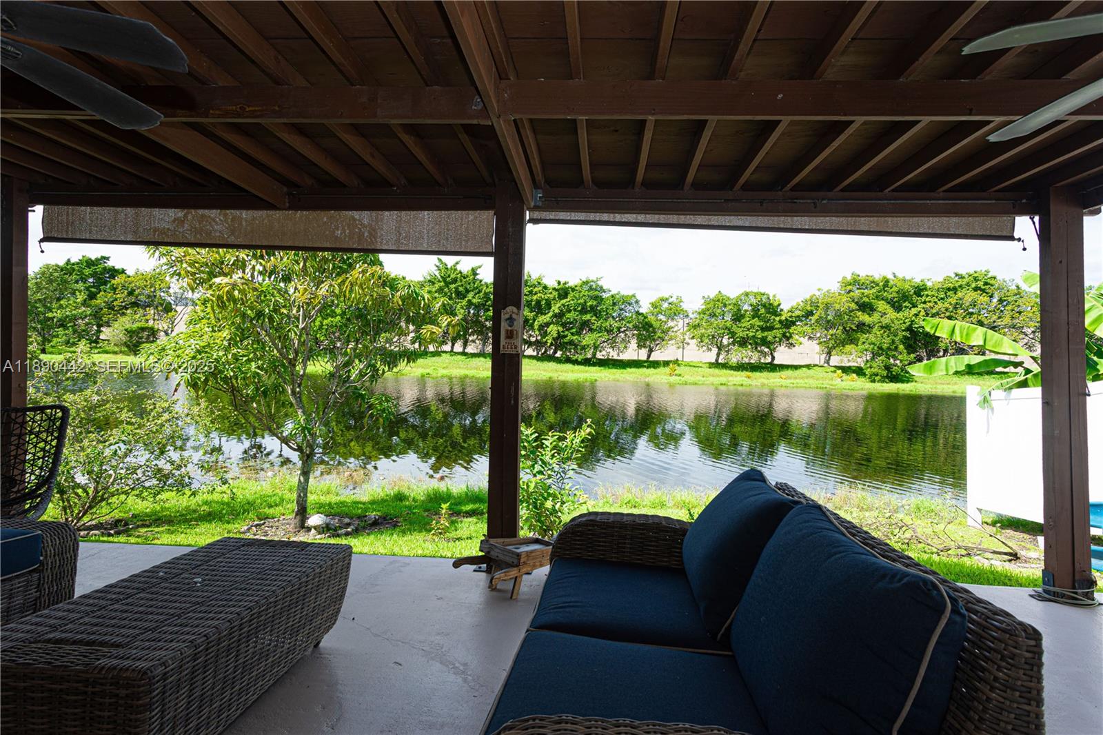 4810 Southwest 153rd Terrace Miramar, FL 33027 - Photo 25 of 41 a view of a patio with couches with wooden floor next to a yard