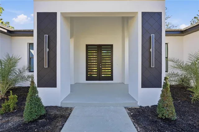 an empty room with wooden floor cabinet and windows