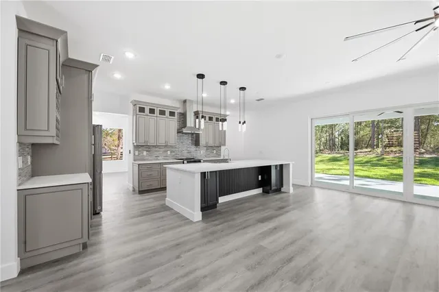 a kitchen with stainless steel appliances granite countertop a stove a sink and a refrigerator
