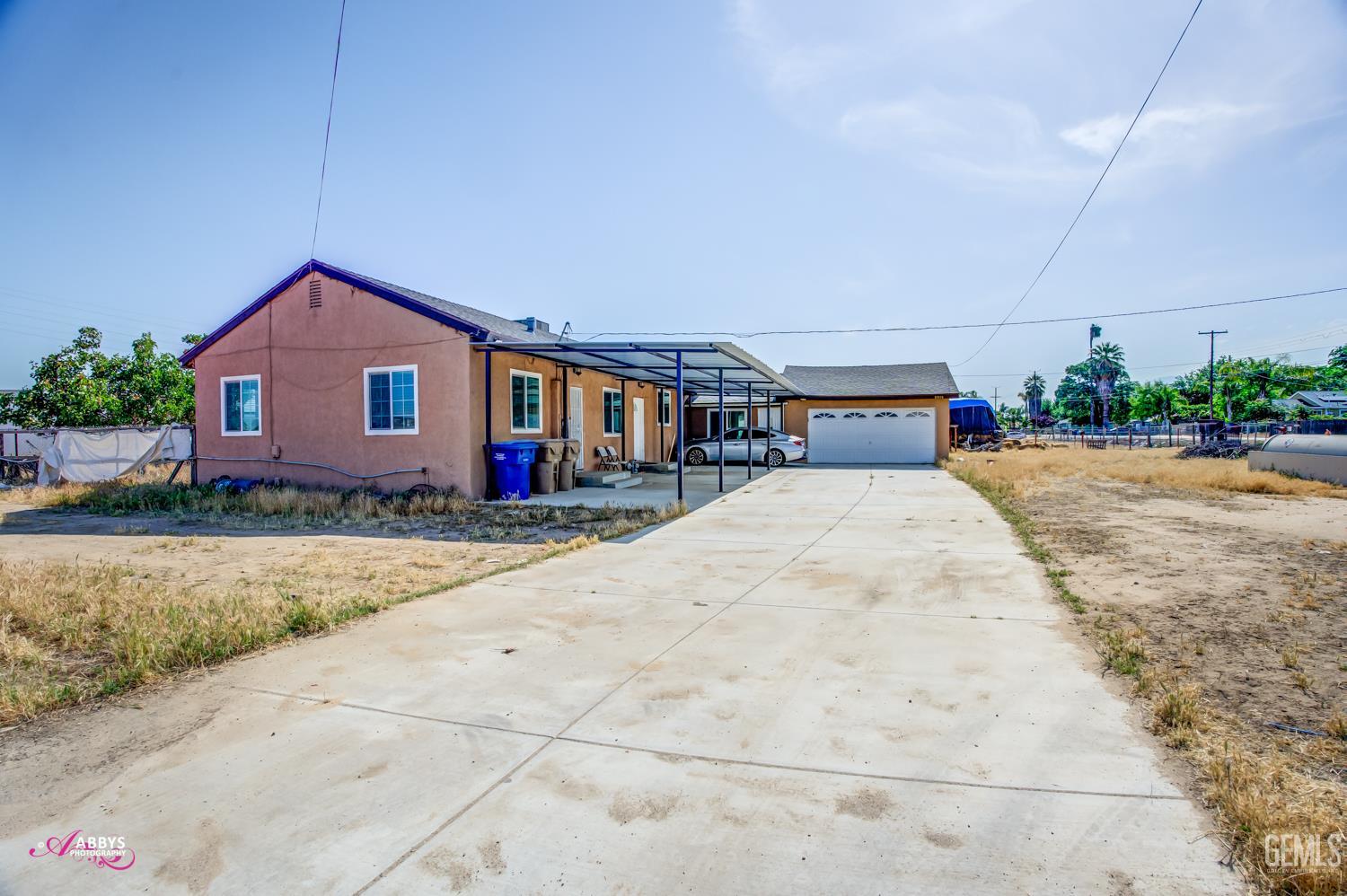 Undisclosed Address Bakersfield, CA 93307 - Photo 3 of 62 a front view of house with yard