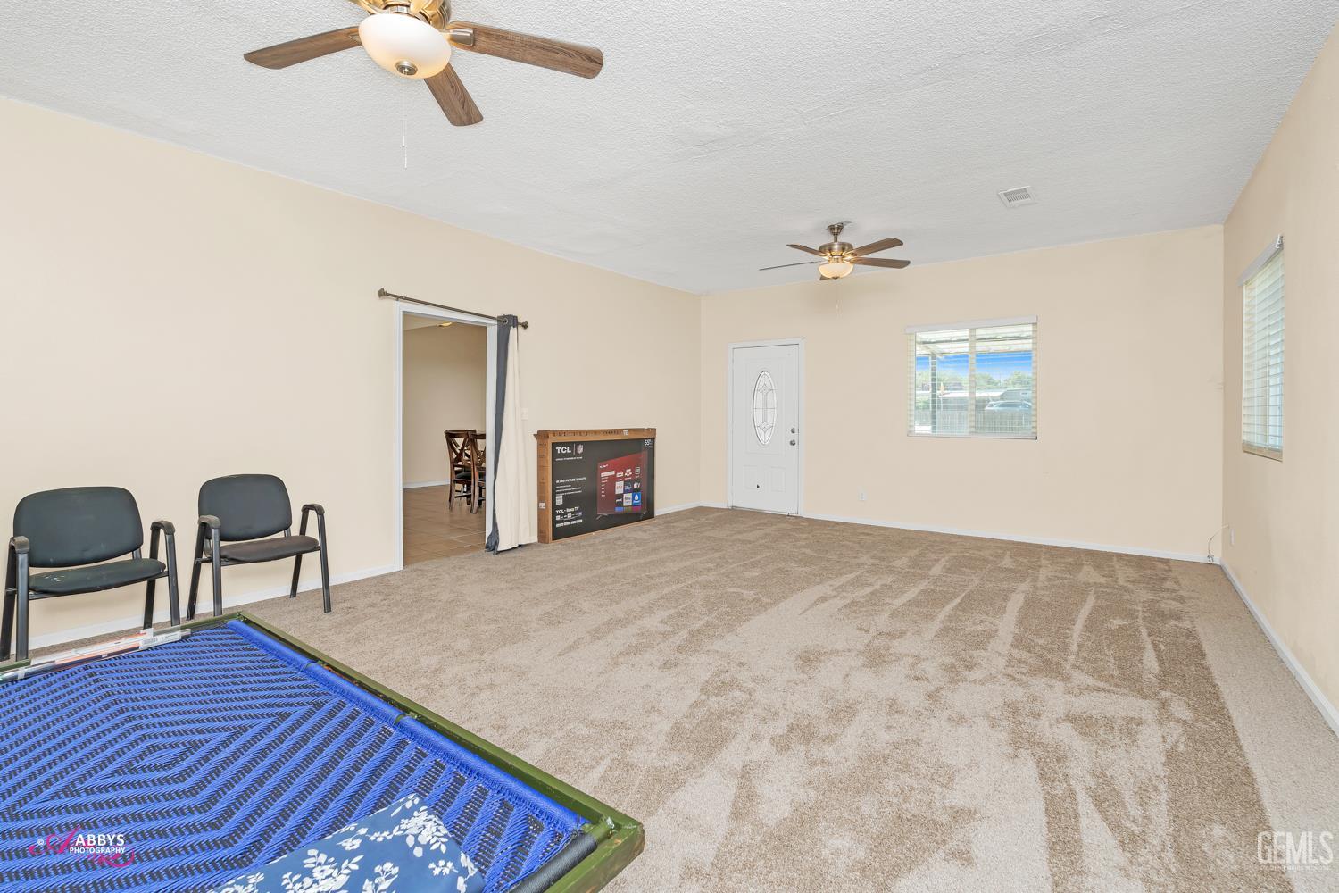 Undisclosed Address Bakersfield, CA 93307 - Photo 52 of 62 a view of a livingroom with furniture and a ceiling fan