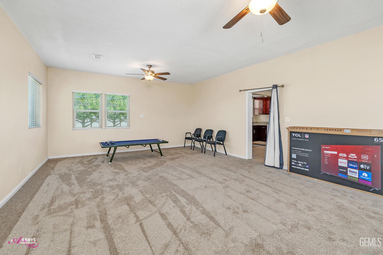 Undisclosed Address Bakersfield, CA 93307 - Photo 53 of 62 an empty room with windows and ceiling fan
