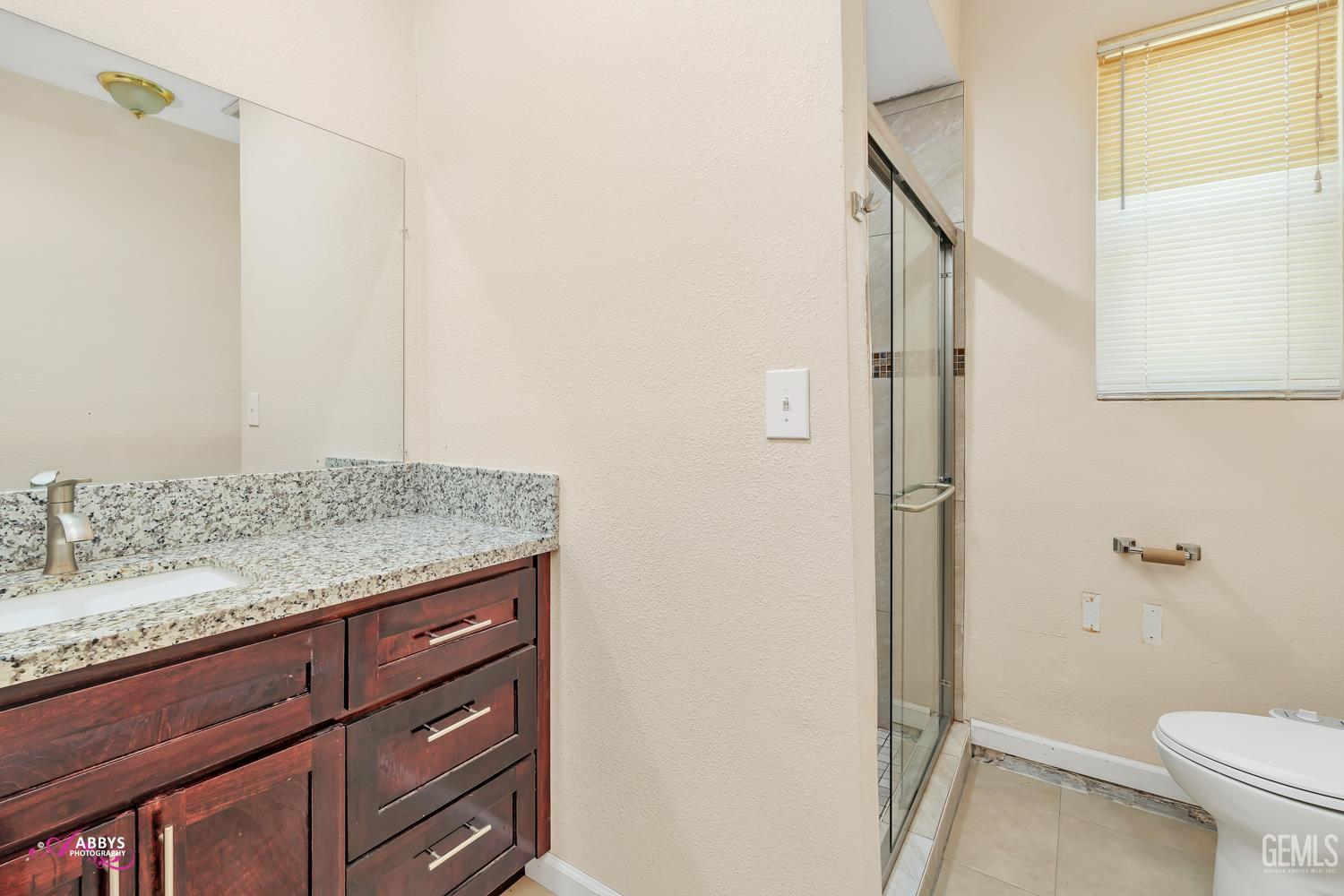 Undisclosed Address Bakersfield, CA 93307 - Photo 56 of 62 a bathroom with a granite countertop sink toilet and shower