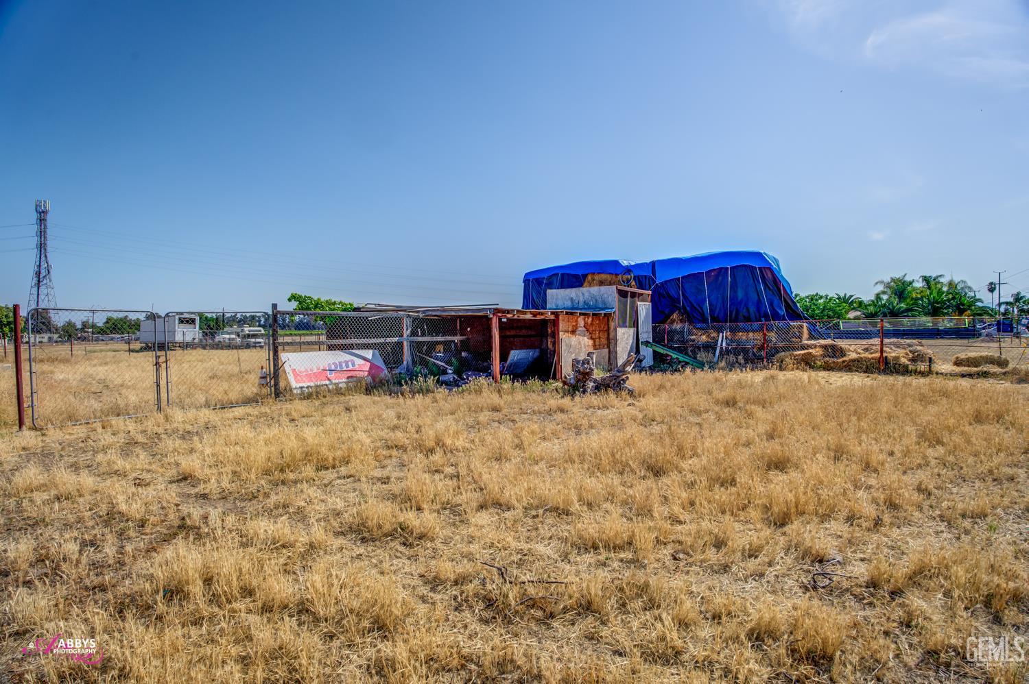 Undisclosed Address Bakersfield, CA 93307 - Photo 6 of 62 a view of swimming pool with outdoor seating and covered with trees in the background
