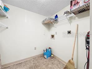 1337 Pine Ridge Circle East, Unit D2 Tarpon Springs, FL 34688 - Photo 11 of 17 a view of walk in closet with clothes and shoes