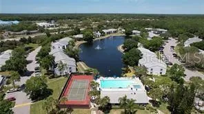 an aerial view of a house with a garden and lake view