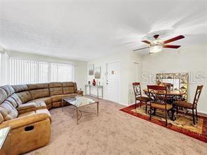 1337 Pine Ridge Circle East, Unit D2 Tarpon Springs, FL 34688 - Photo 5 of 17 a living room with furniture