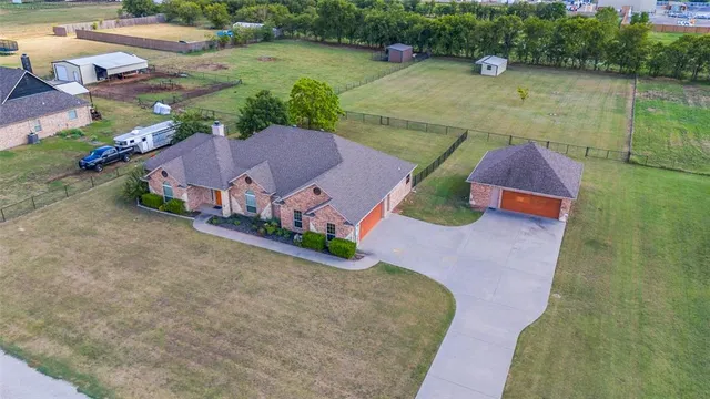 an aerial view of a house with outdoor space