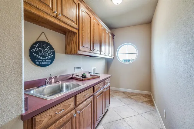 a kitchen with a sink cabinets and a window
