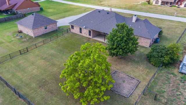 an aerial view of house with yard