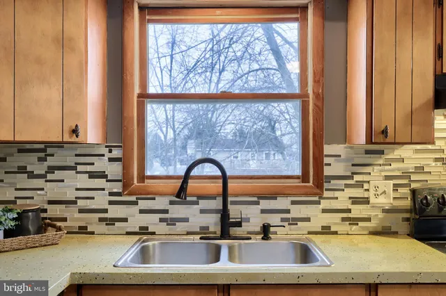 a kitchen with kitchen island a sink a counter and a window